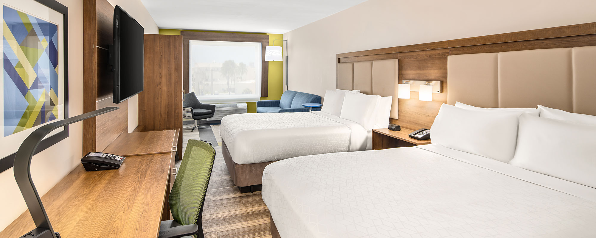 guest suite with two queen beds and sofa